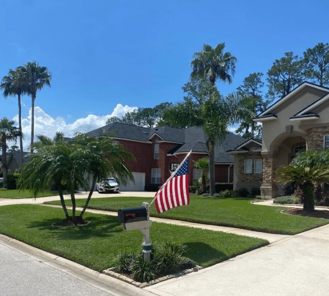 Well-maintained front lawn and palms at a Green Cove Springs, FL home