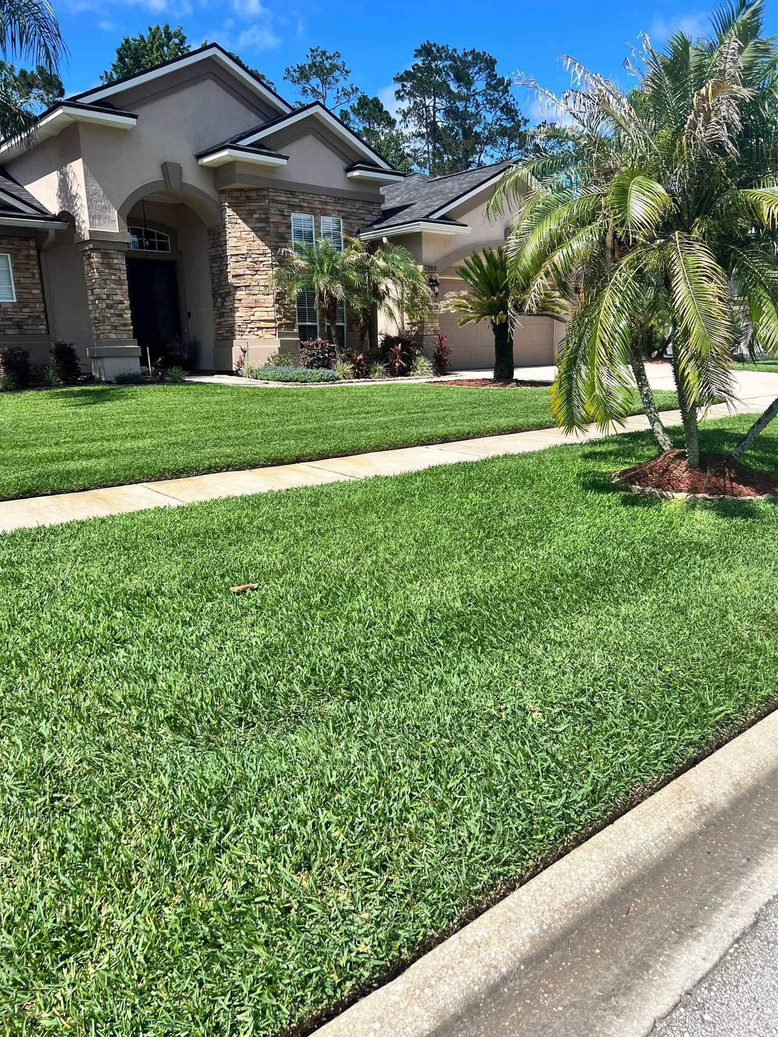 Lawn top dressing company spreading material on an Oakleaf Plantation, FL lawn